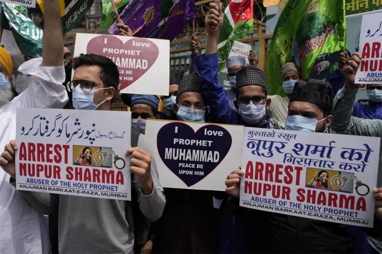 Indian Muslims hold placards demanding the arrest of Nupur Sharma