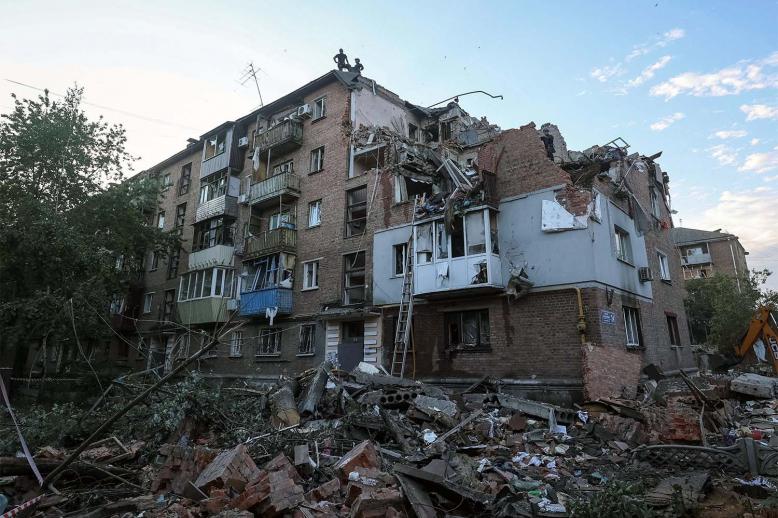 Rescuers work at a site of a residential building in kharkiv hit by a Russian missile strike