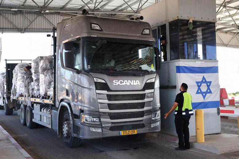 A trucks carrying humanitarian aid drives through the Kerem Shalom crossing 