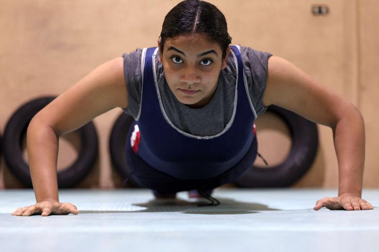 Wrestler Rodaina Gamal, 15, in action during a training session at the one-room Manshiya club in El Mansoura, Egypt, December 15, 2025. 