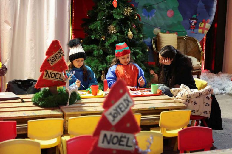 Children paint at a Christmas market during holiday season in downtown Beirut.