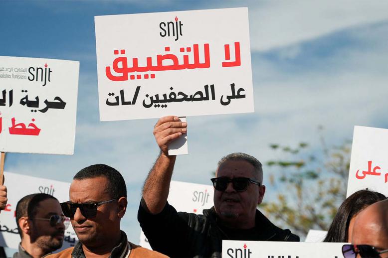 Tunisian journalists rally near the governments office, holding signs to protest press restrictions, call for greater freedom on November 20, 2025