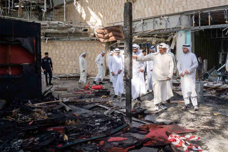 Kuwaiti officials inspect damage inside a terminal at Kuwait International Airport following an Iranian drone and missile attack