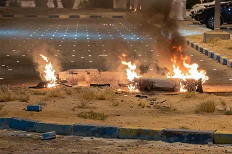 Debris burns on the ground in a parking lot following reports of missile and drone attacks, in Sabah Al Nasser, Kuwait