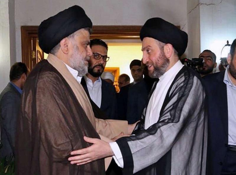 Shia cleric Muqtada al-Sadr (L) greets Shia leader Ammar al-Hakim in Baghdad, on May 22