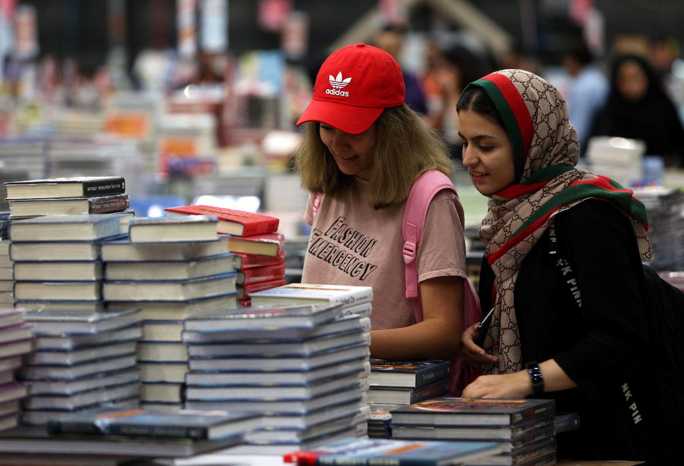 Visitors read books at the Big Bad Wolf Book Sale.