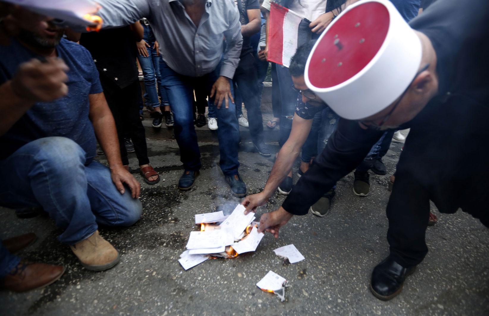 Druze residents of Majdal Shams in the Israeli-annexed Golan Heights set ablaze makeshift ballot papers during a protest on October 19, 2018.