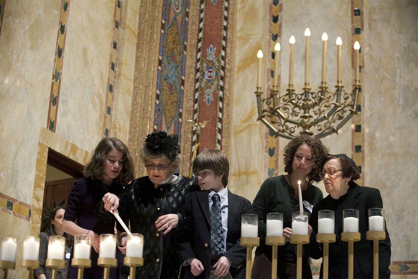 Holocaust survivors light symbolic candles at the Temple Emanu-El during the annual Holocaust Remembrance Day in New York