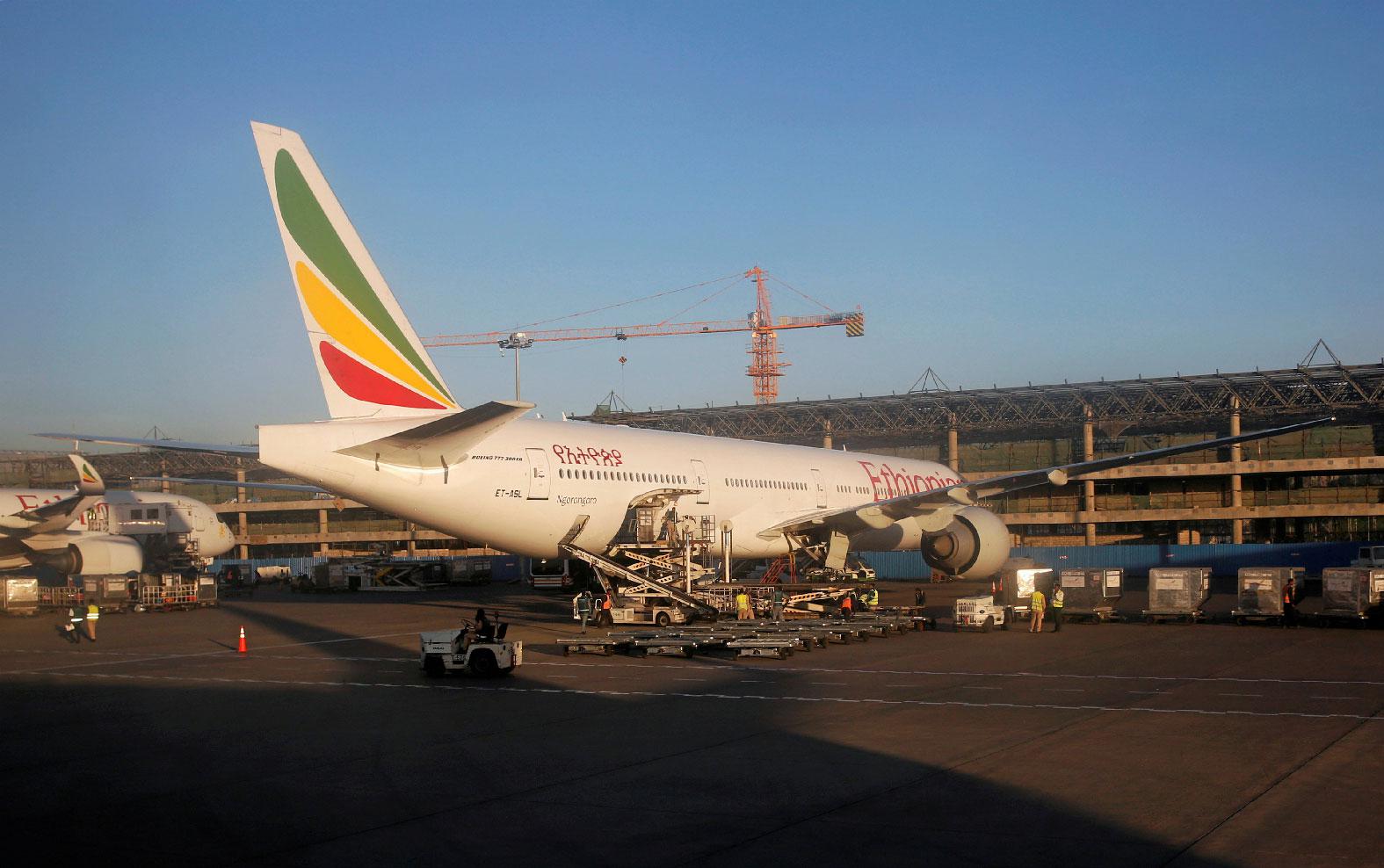 Workers service an Ethiopian Airlines plane at the Bole International Airport in Ethiopia's capital Addis Ababa