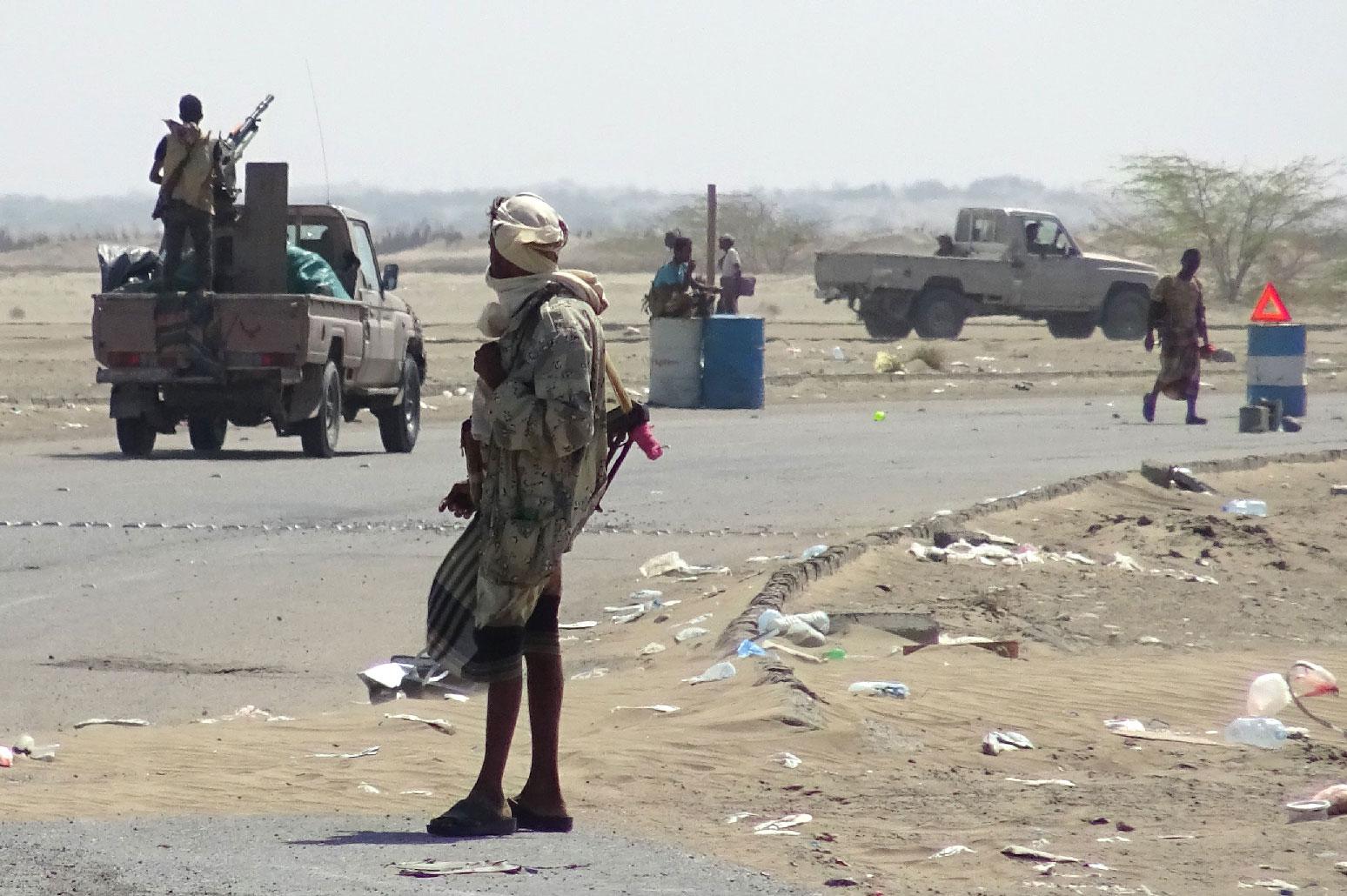 Yemeni pro-government forces gather at a checkpoint in a street on the eastern outskirts of Hodeidah.