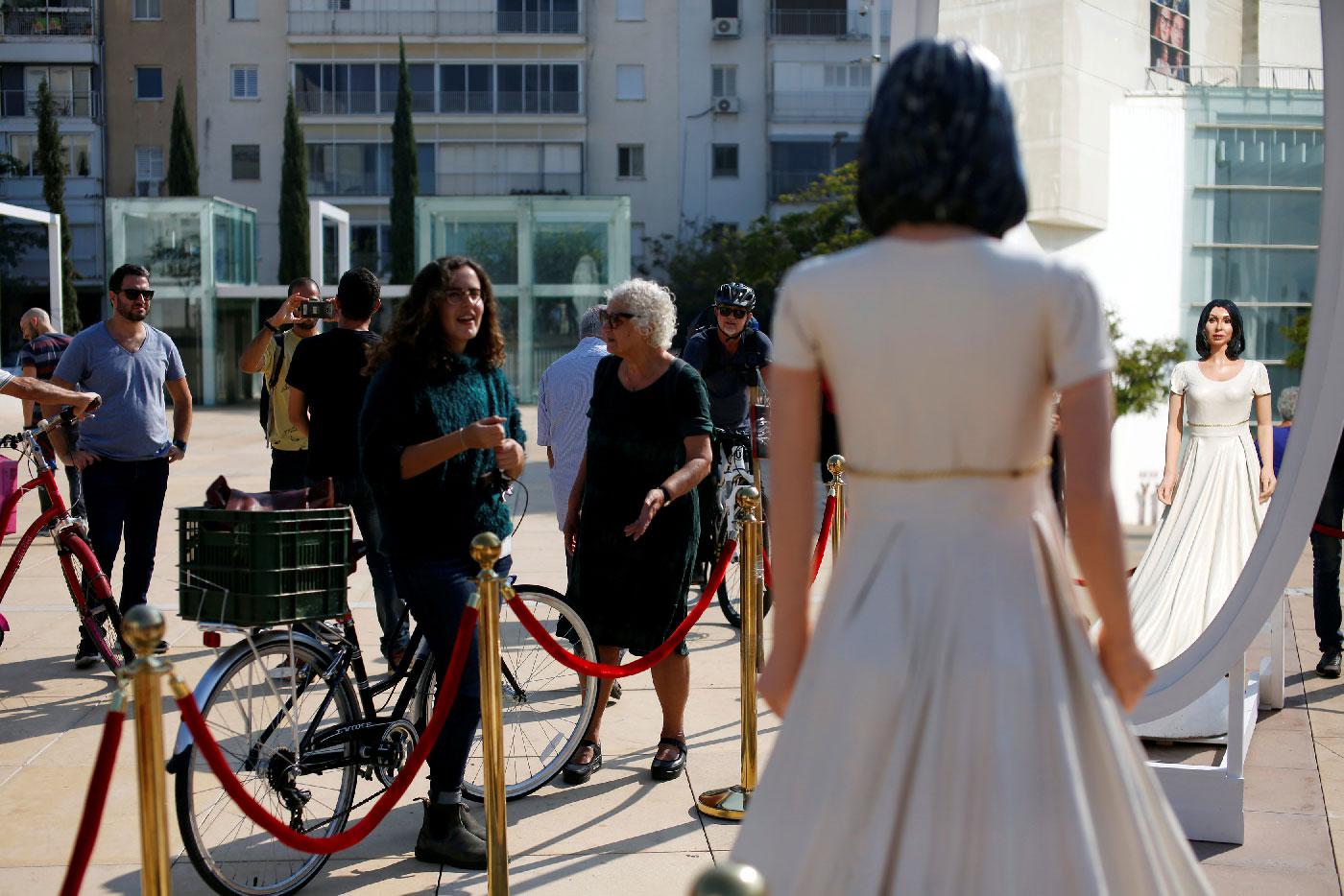 People look at an installation, including a statue resembling Israeli Minister of Sports and Culture, Miri Regev, in Tel Aviv, Israel on November 8, 2018.