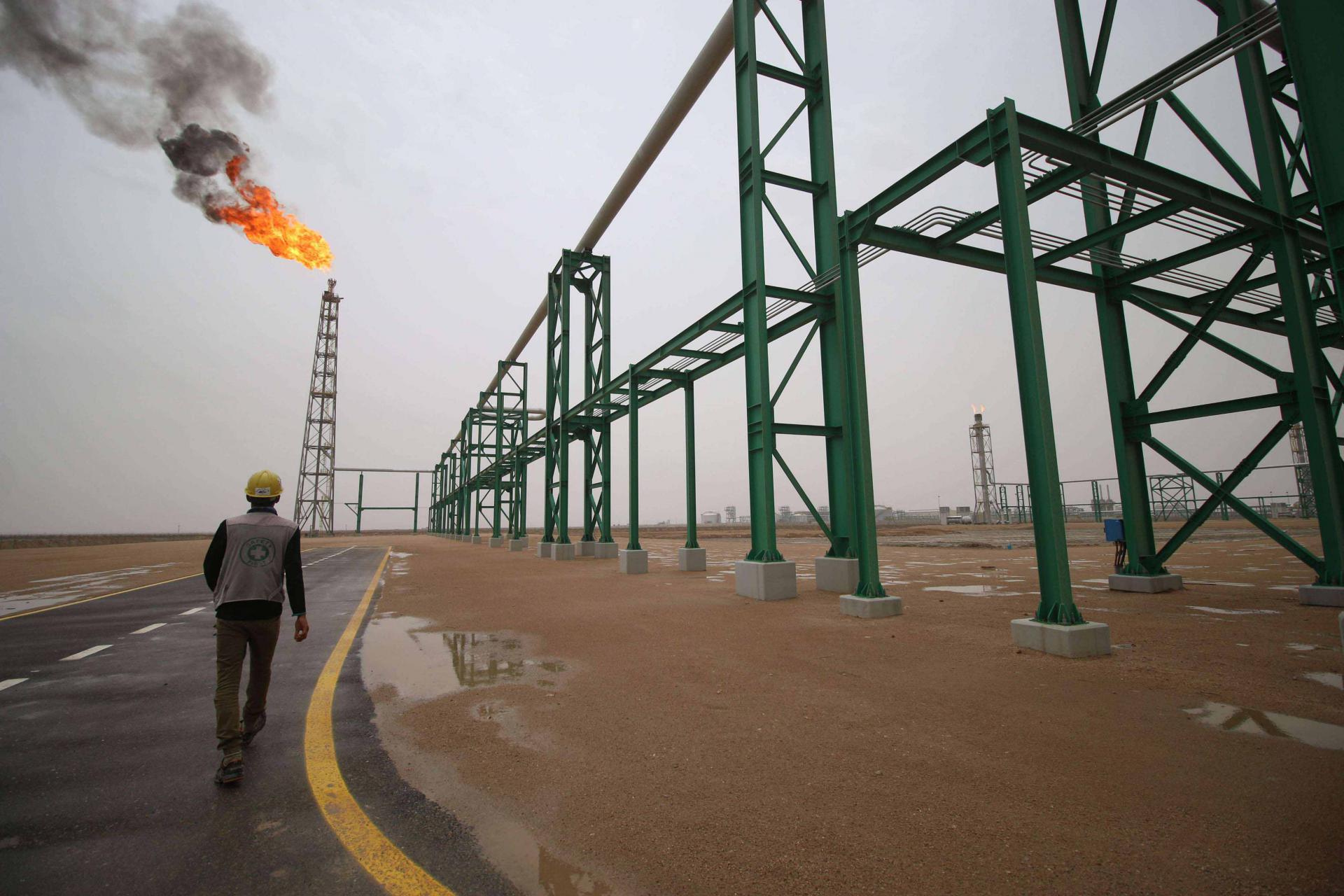  An employee walks at the Zubair oil and gas field in Basra, last May
