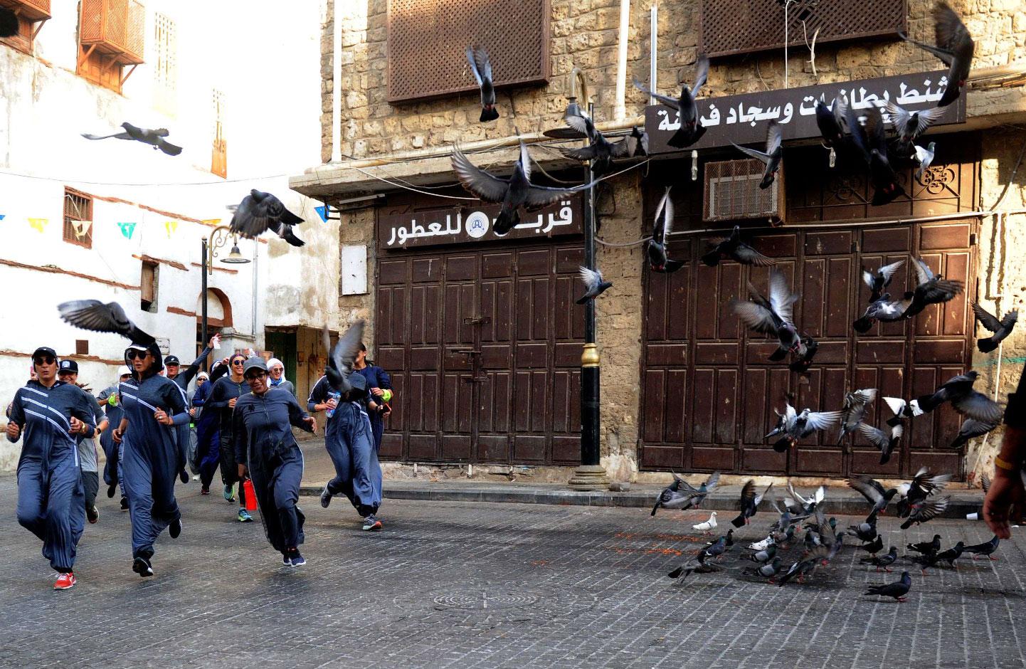  Saudi women jog in the streets of Jeddah's historic al-Balad district on March 8, 2018.