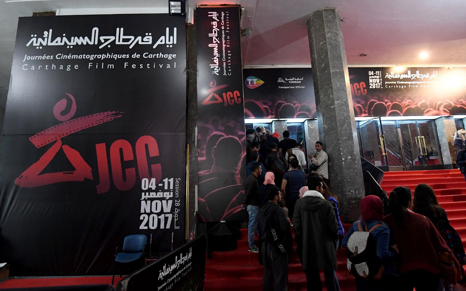 Tunisians standing in a queue outside a movie theatre in Tunis, during the 28th edition of the Carthage Film Festival on November 08, 2017.