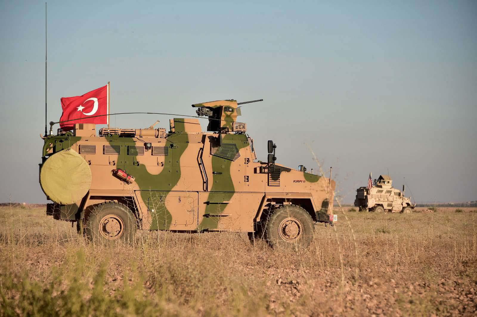 Turkish and U.S. troops conduct joint patrols around the Syrian town of Manbij