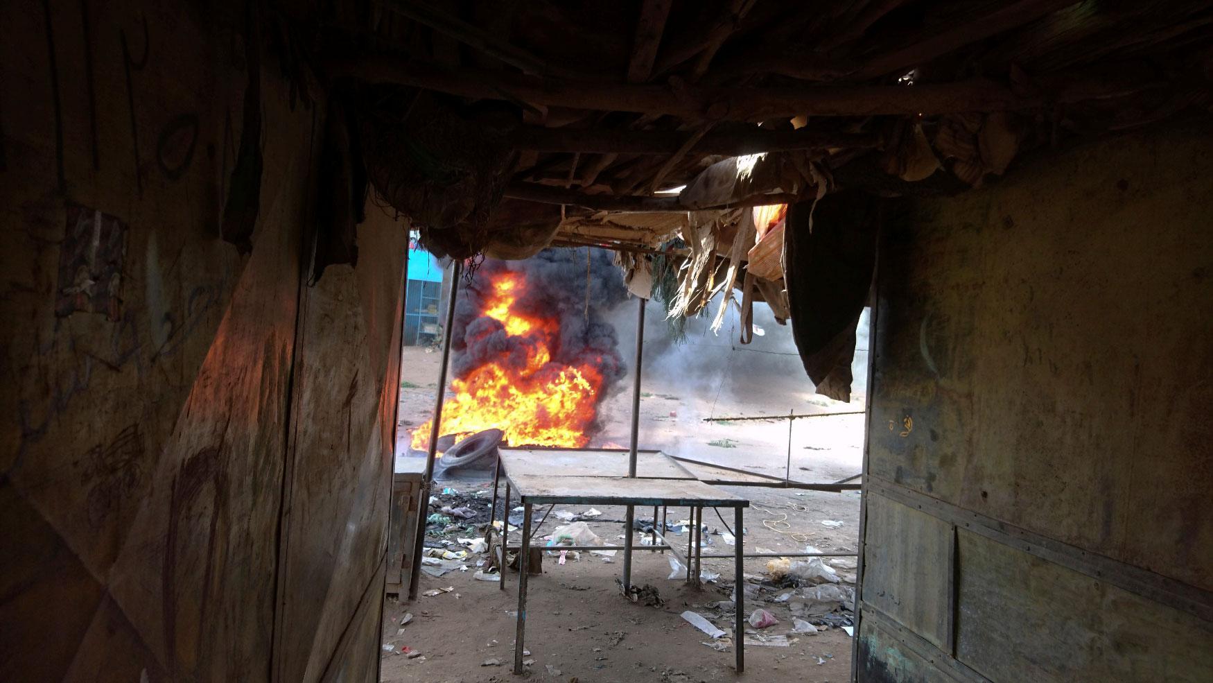 A bonfire is lit along the street during protests against price increases in Atbara, Nile River state in northeastern Sudan December 20, 2018.