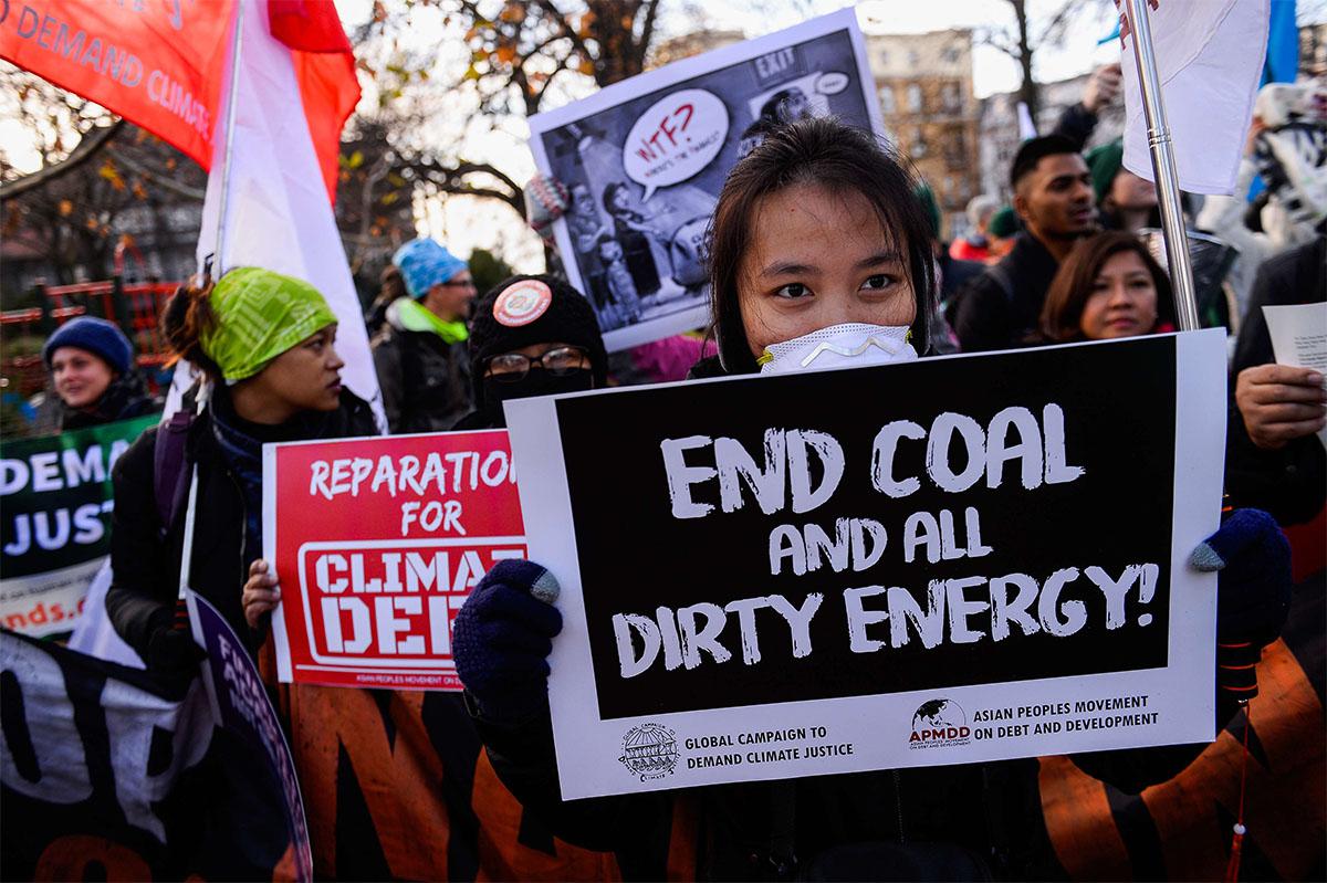 People march with placards during a demonstration against climate change in Katowice