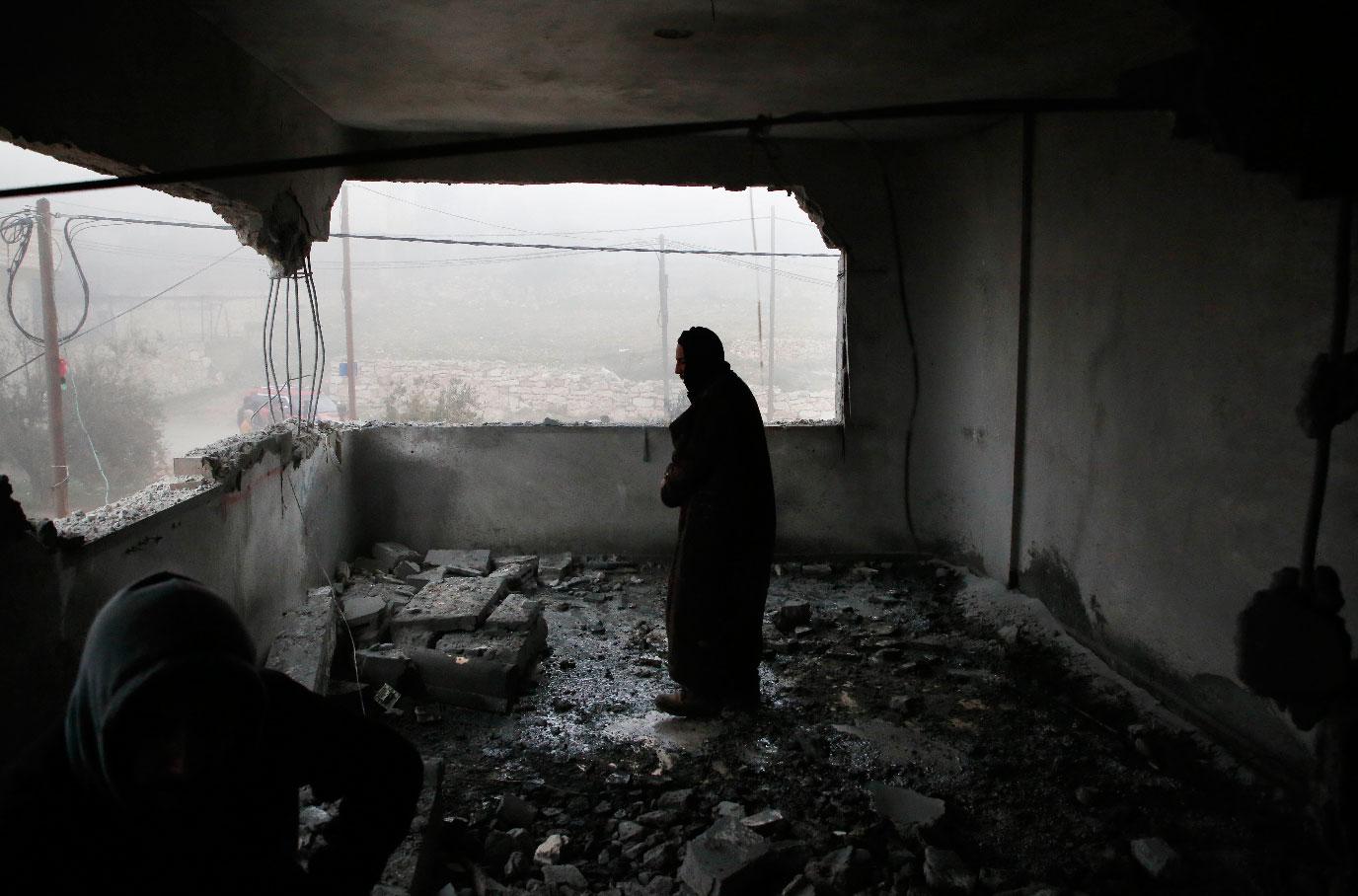 A Palestinian man checks the house of man accused of the fatal September stabbing of an Israeli-American, after it was partially demolished by Israeli forces on January 18, 2019 in village of Yatta in the occupied West Bank south of Hebron.