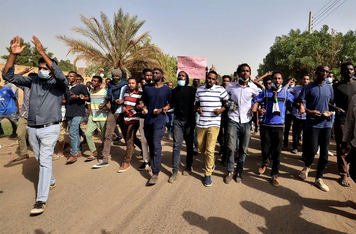 Sudanese demonstrators chant slogans as they participate in anti-government protests in Khartoum