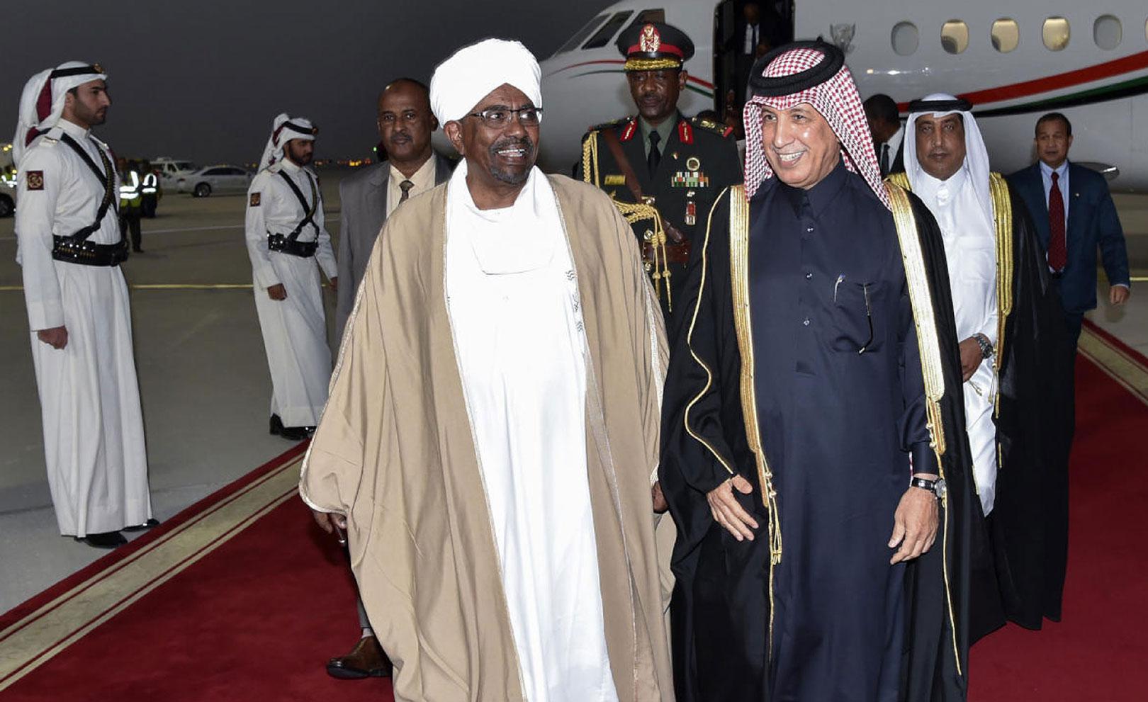 A handout picture released by the Qatar News Agency (QNA) on January 23, 2019 shows Sudanese President Omar al-Bashir (R) being received by Qatari Minister of State for Foreign Affairs Sultan bin Saad al-Muraikhi in Doha.