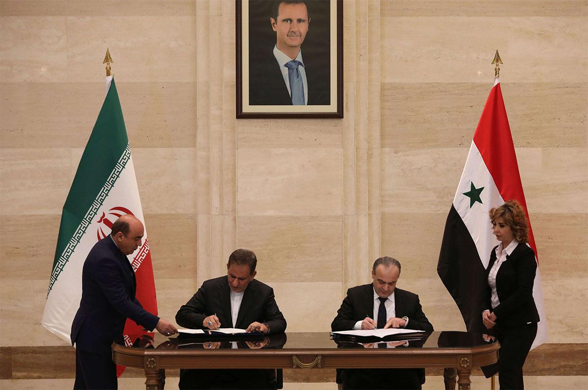 Syrian PM Imad Khamis (C-R) and Iranian Vice President Eshaq Jahangiri (C-L) attend the signing ceremony in Damascus
