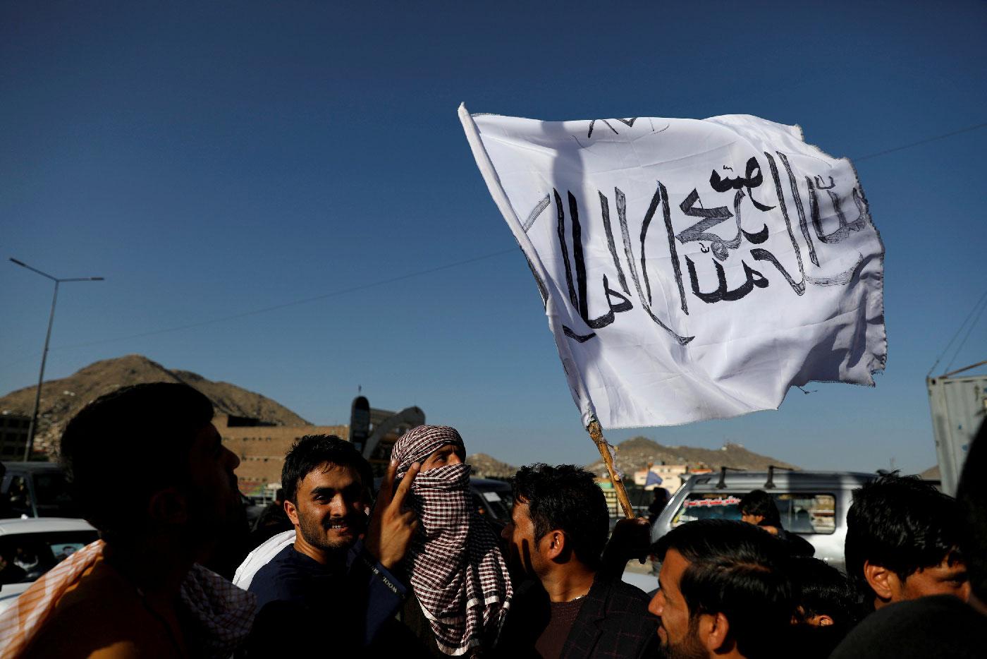 A member of the Taliban holds a flag in Kabul, Afghanistan June 16, 2018.