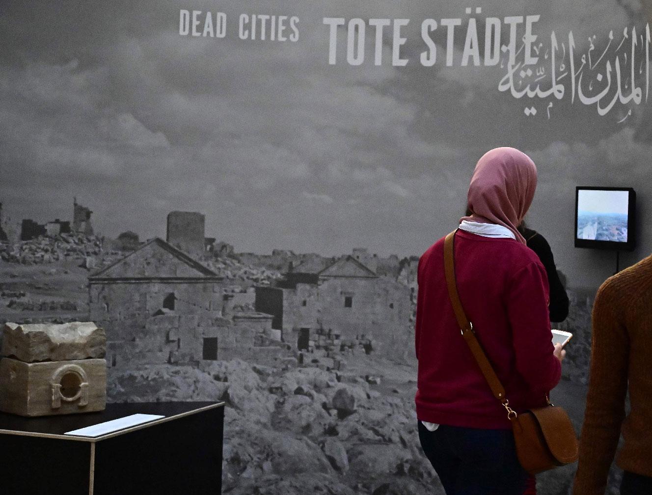 A woman visits the exhibition titled "Cultural Landscape of Syria - Preservation and Archiving in Times of War" at the Museum of Islamic Art in the Pergamon Museum on February 27, 2019 in Berlin.