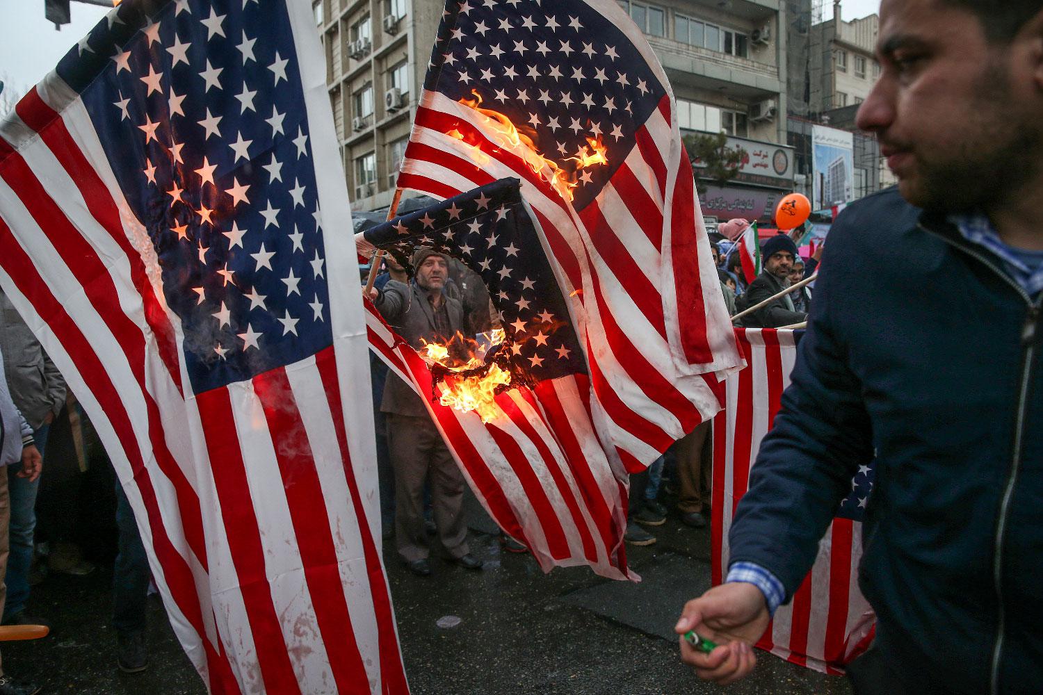 Iranians burn U.S. flags during a ceremony to mark the 40th anniversary of the Islamic Revolution in Tehran, Iran February 11, 2019. 