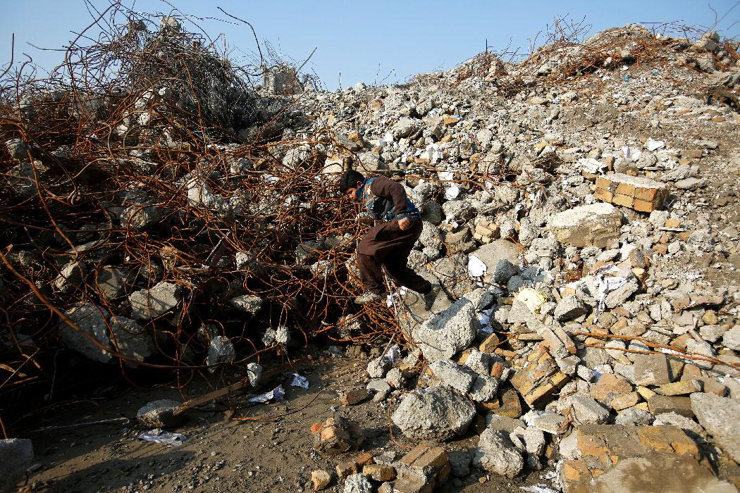 Homeless boys search for scrap in the remains of the former National Insurance Company building in the Old City of Mosul, Iraq February 1, 2019. 