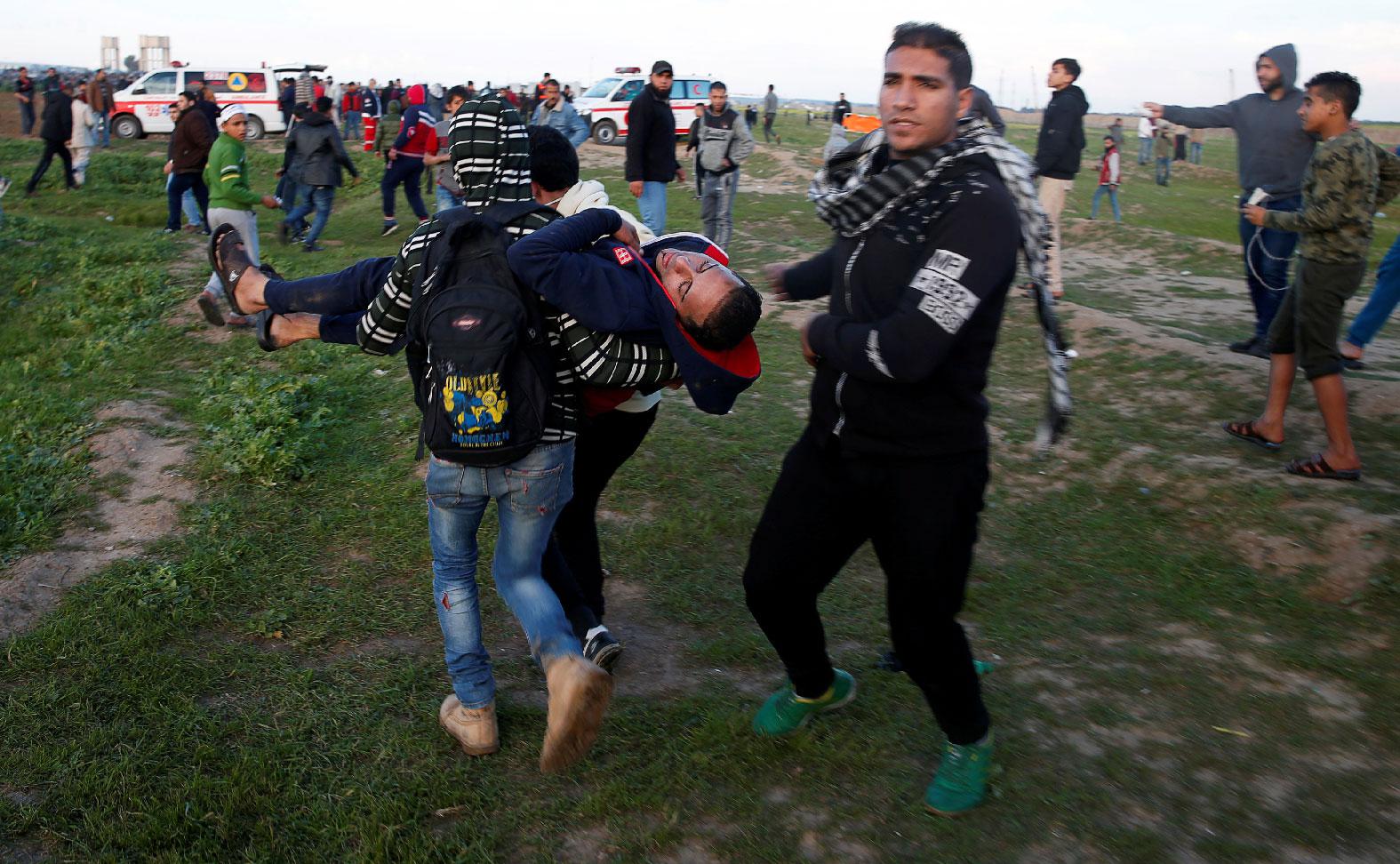 A wounded Palestinian is evacuated during a protest at the Israel-Gaza border fence, east of Gaza City February 22, 2019.