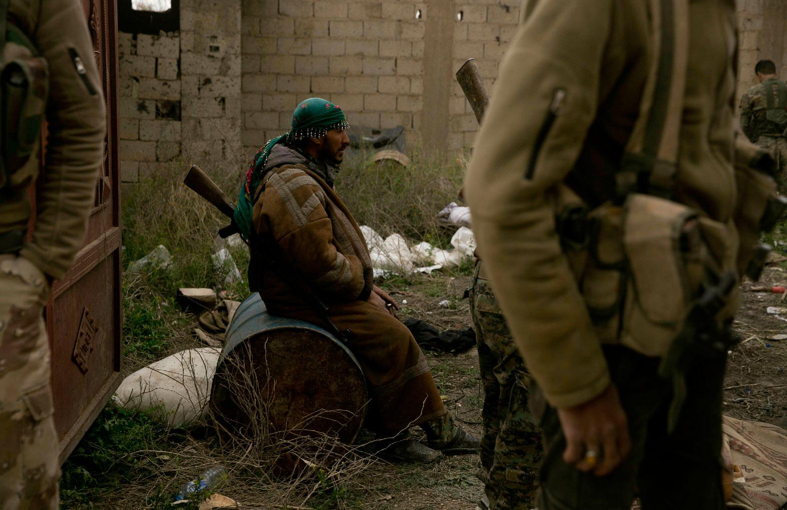 U.S.-backed Syrian Democratic Forces (SDF) wait outside Baghouz, Syria, to go to the front line where Islamic State militants are staging counter attacks, Thursday, March 14, 2019.