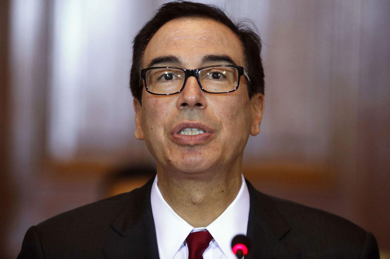 In this Oct. 16, 2018, photo Treasury Secretary Steve Mnuchin leads a meeting of the Financial Stability Oversight Council at the Treasury Department in Washington.