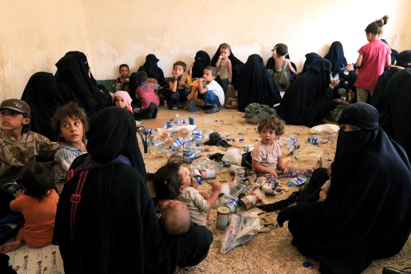 Families and relatives of Islamic State militants are seen after they surrender themselves to the Kurdish Peshmerga forces in al-Ayadiya, northwest of Tal Afar, Iraq, August 30, 2017.