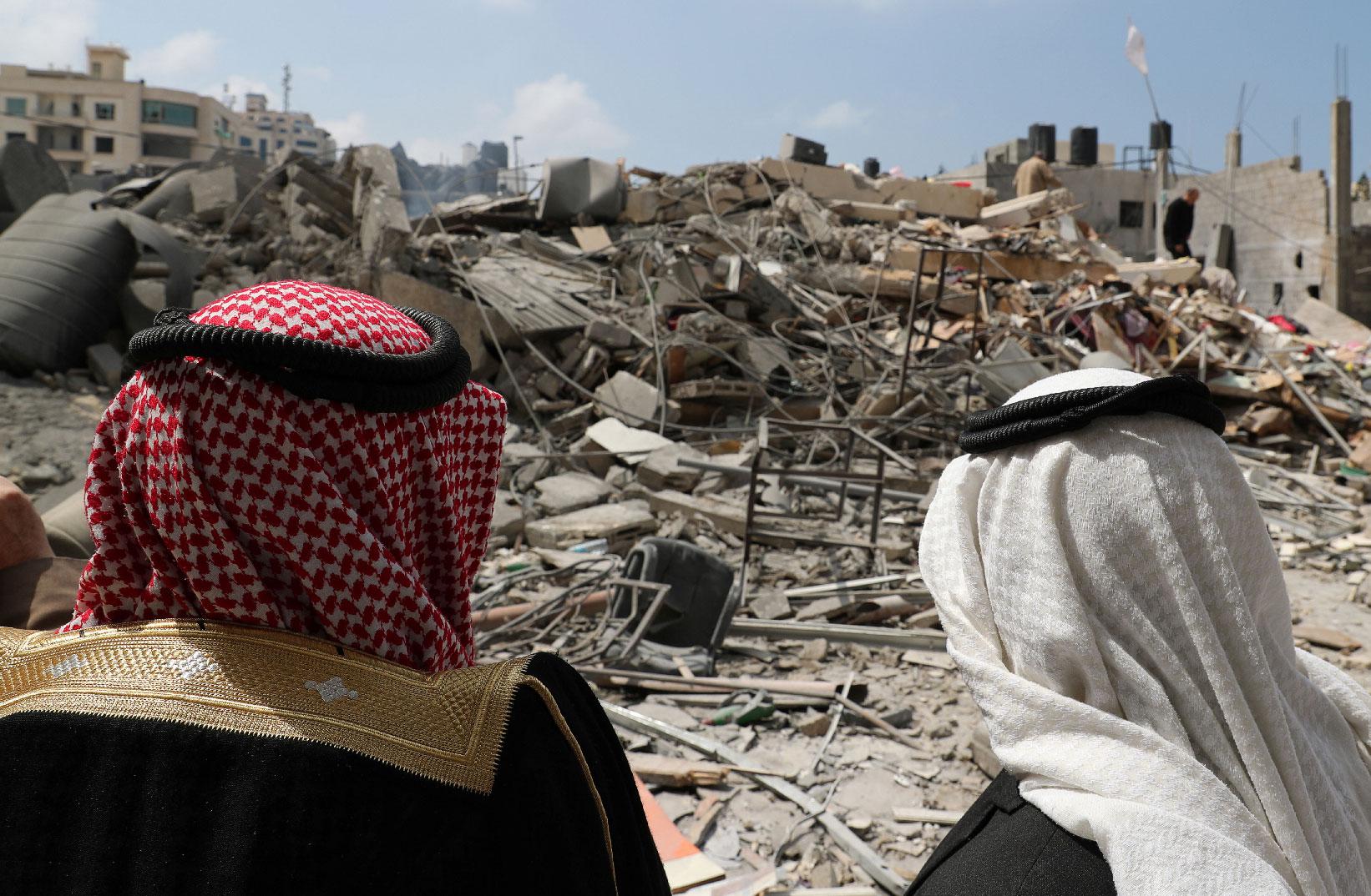 Palestinians look at a destroyed Hamas site that was bombed in an Israeli air strike on Monday, in Gaza City March 27, 2019.