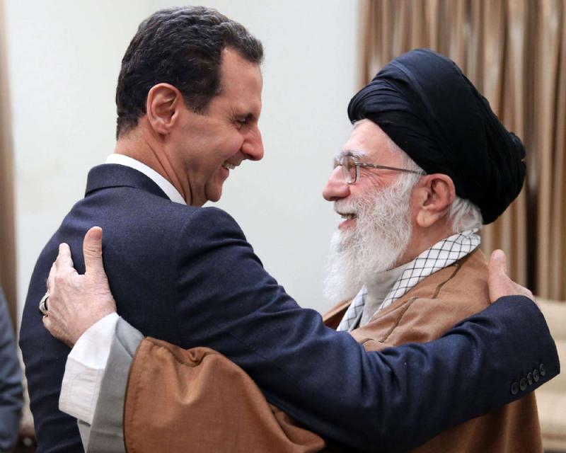 Iranian Supreme Leader Ayatollah Ali Khamenei (R) welcomes Syrian President Bashar Assad in Tehran, on February 25