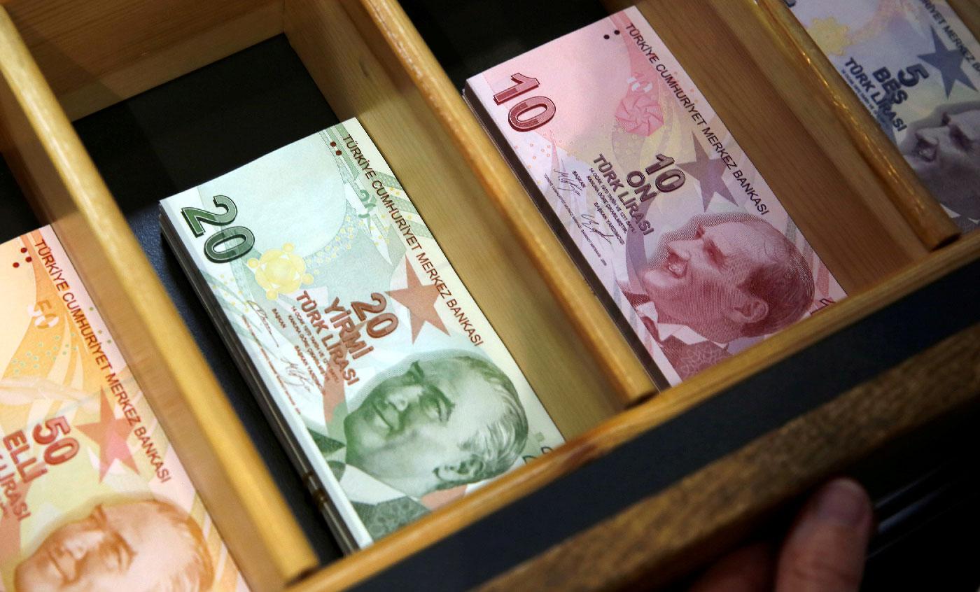 Turkish lira banknotes are pictured at a currency exchange office in Istanbul, Turkey August 13, 2018.