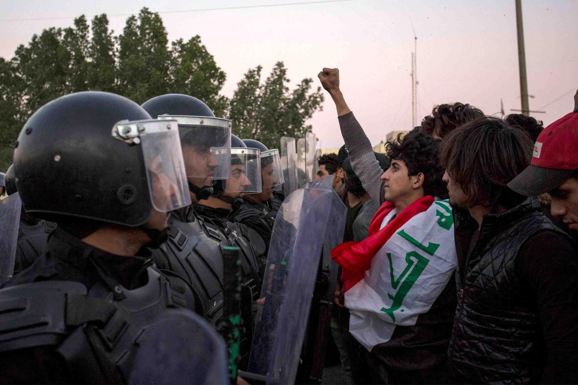 Iraqi security forces confront protesters demonstrating against government policies and lack of basic services in Basra, January 4