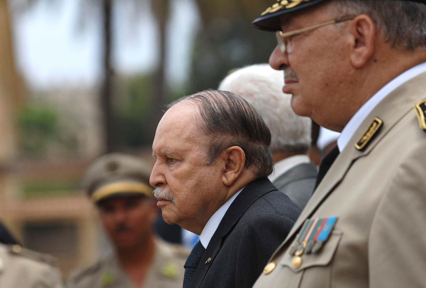 In this picture taken on June 27, 2012, Algerian President Abdelaziz Bouteflika, left, and his Army chief of staff, Gen. Ahmed Gaid Salah, review an honor guard before attending a military parade, in Cherchell near Algiers, Algeria.