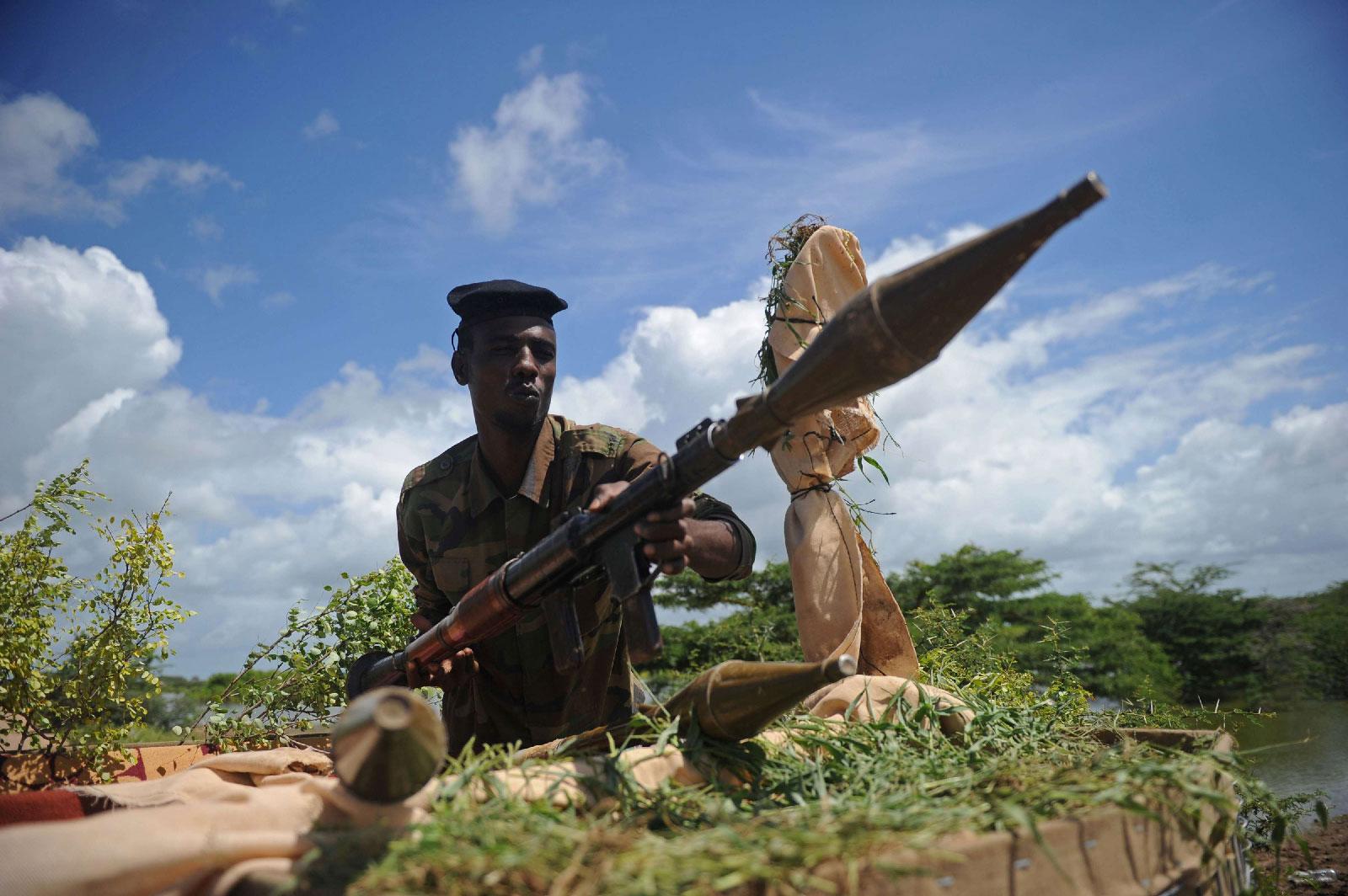 A Somali soldier holds a mortar gun at Sanguuni military base south of Mogadishu, Somalia.