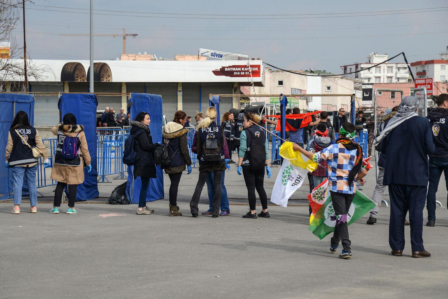 Turkish police officers check supporters of Peoples' Democratic Party (HDP) arriving for an election campain rally of HDP in Batman, south east Turkey on March 12, 2019.