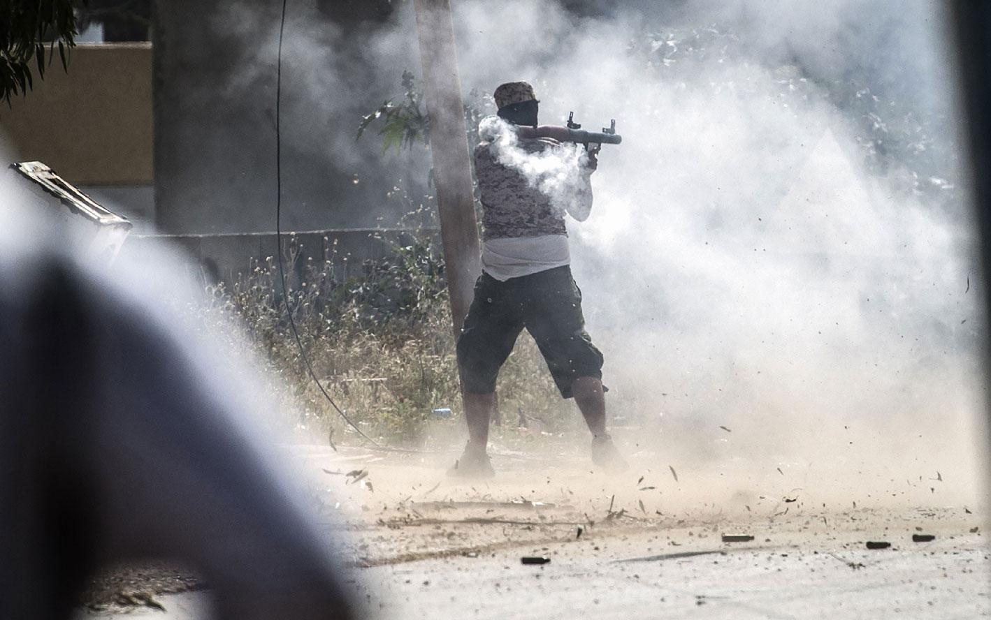 A fighter loyal to the GNA fires a rocket-propelled grenade in Tripoli