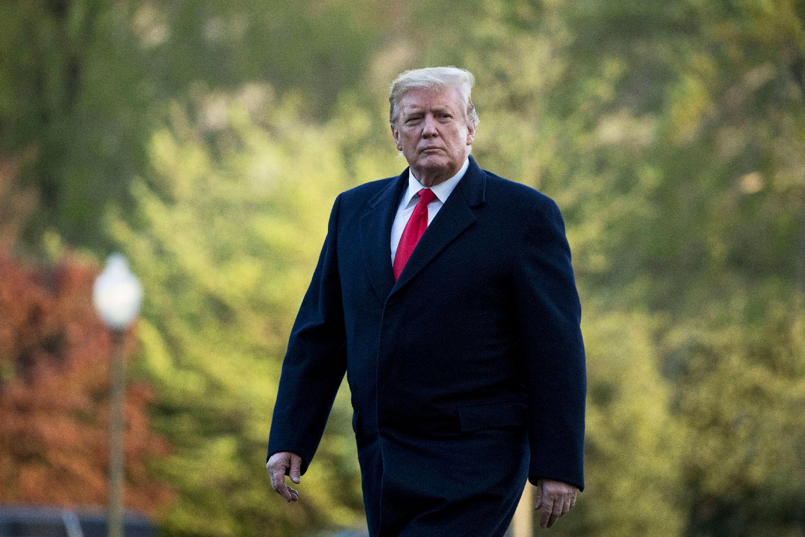 President Donald Trump walks on the South Lawn as he arrives at the White House in Washington