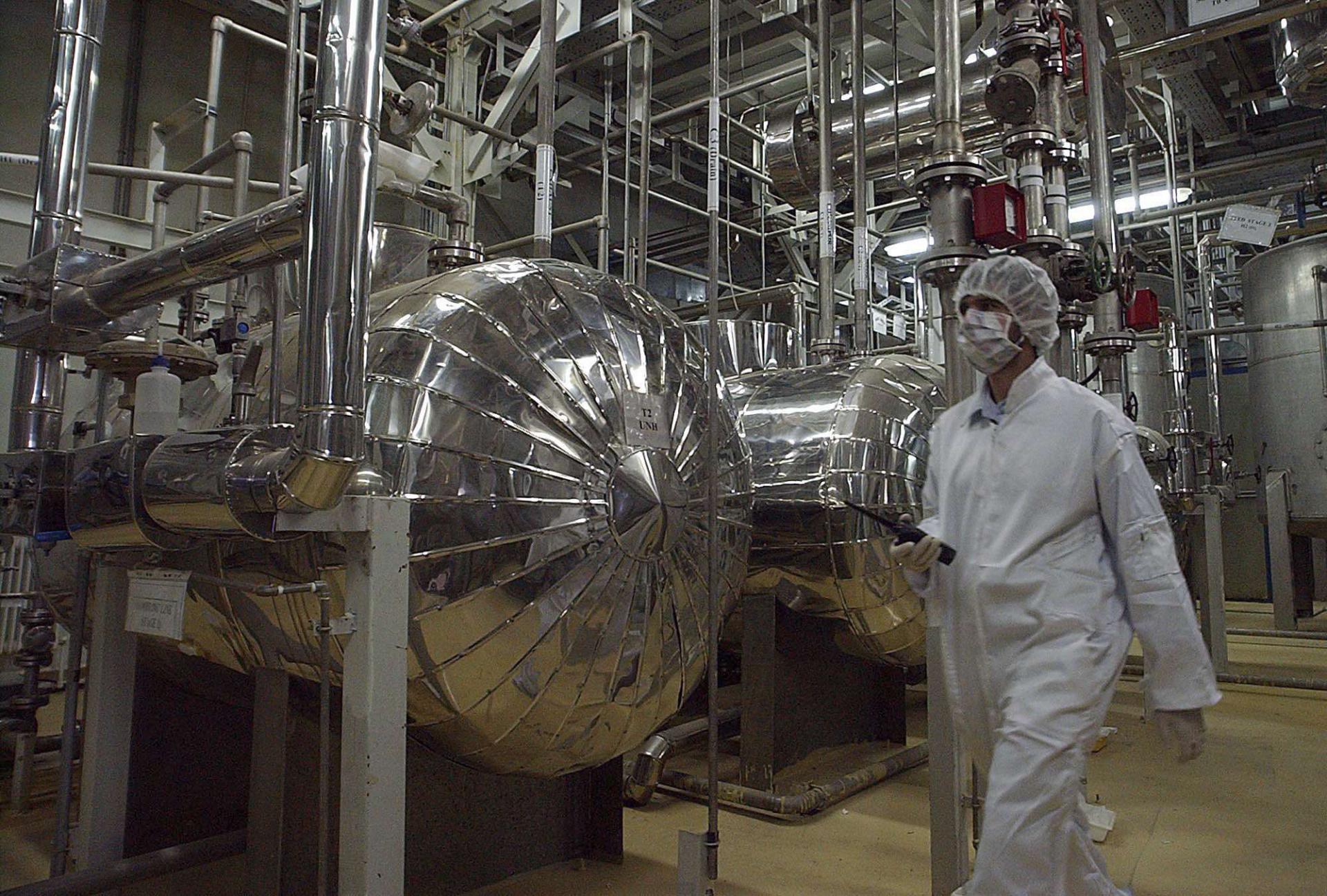  Iranian security official in protective clothing walks through part of the Uranium Conversion Facility just outside the Iranian city of Isfahan