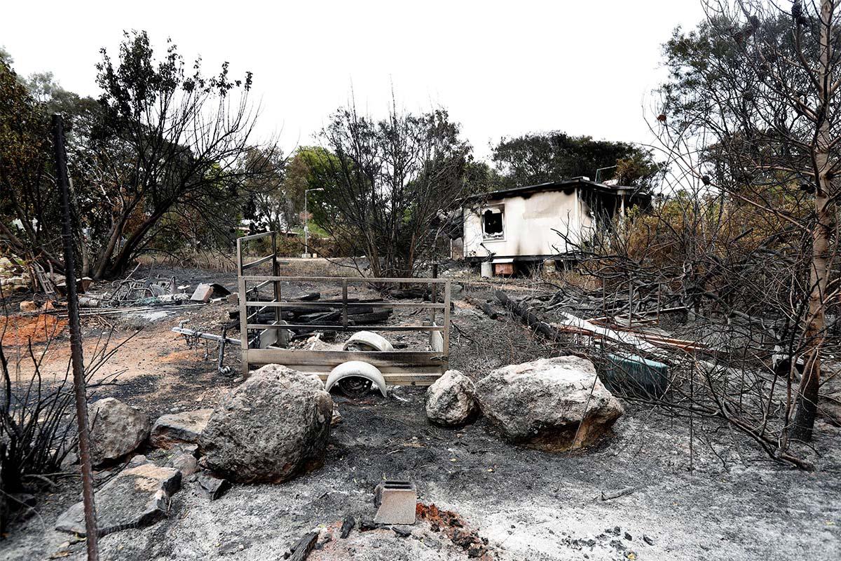 A house and its surroundings damaged by wildfires are seen at kibbutz Harel during a record heatwave in Israel