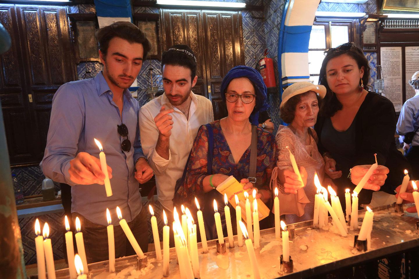 Jewish pilgrims light candles on the first day of the annual pilgrimage to the El Ghriba Synagogue