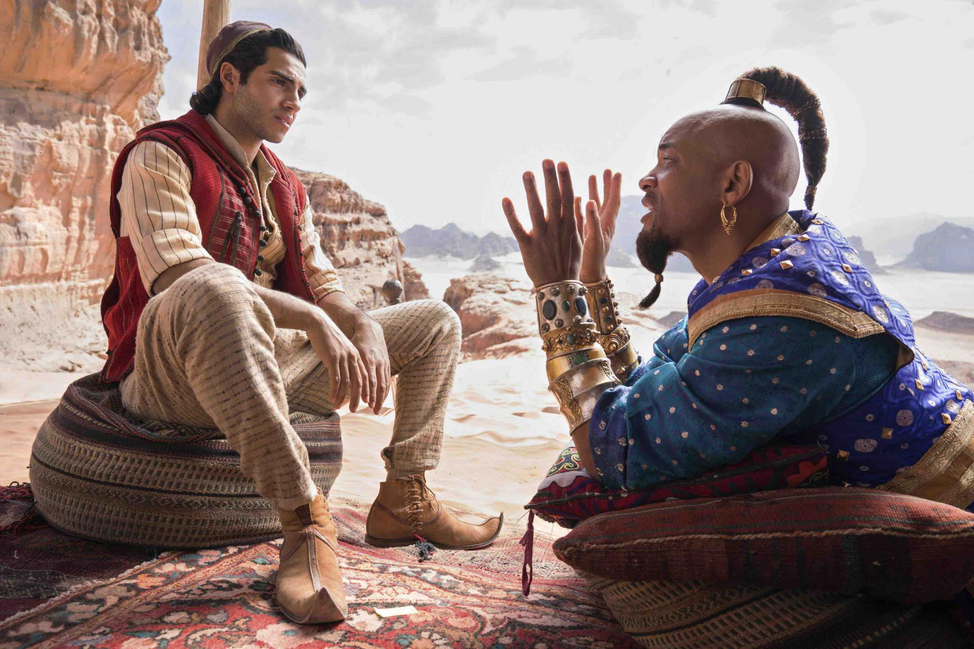Mena Massoud as Aladdin (L) and Will Smith as Genie in Disney’s live-action adaptation of the 1992 animated classic “Aladdin.”
