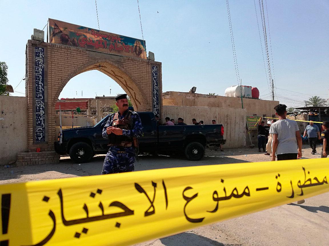 Security forces gather at the site of the attack in Baghdad