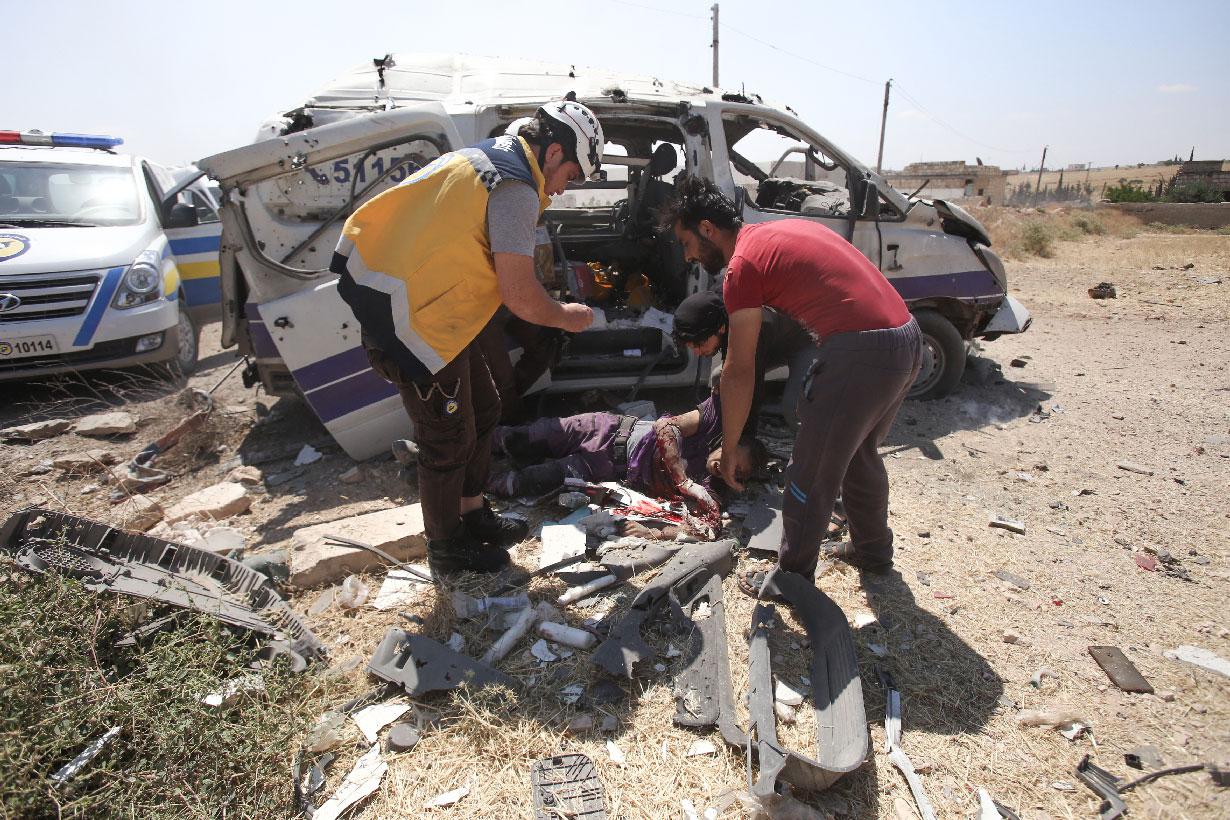 Injured medic receives help after an ambulance was destroyed by a Syrian government air strike