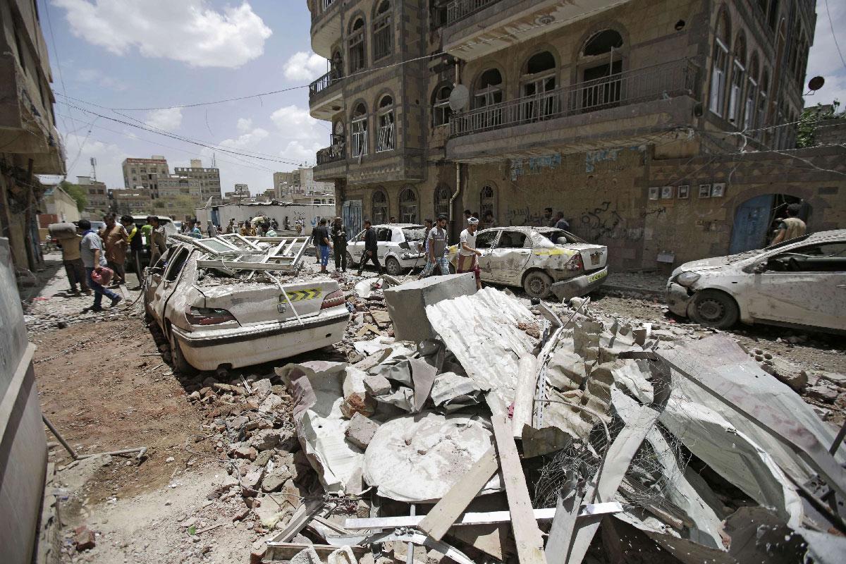People inspect the site of an airstrike by Saudi-led coalition in Sanaa