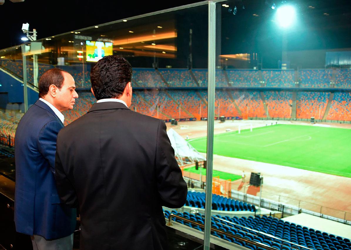 Egyptian President Abdel-Fattah el-Sissi, left, inspects Cairo Stadium